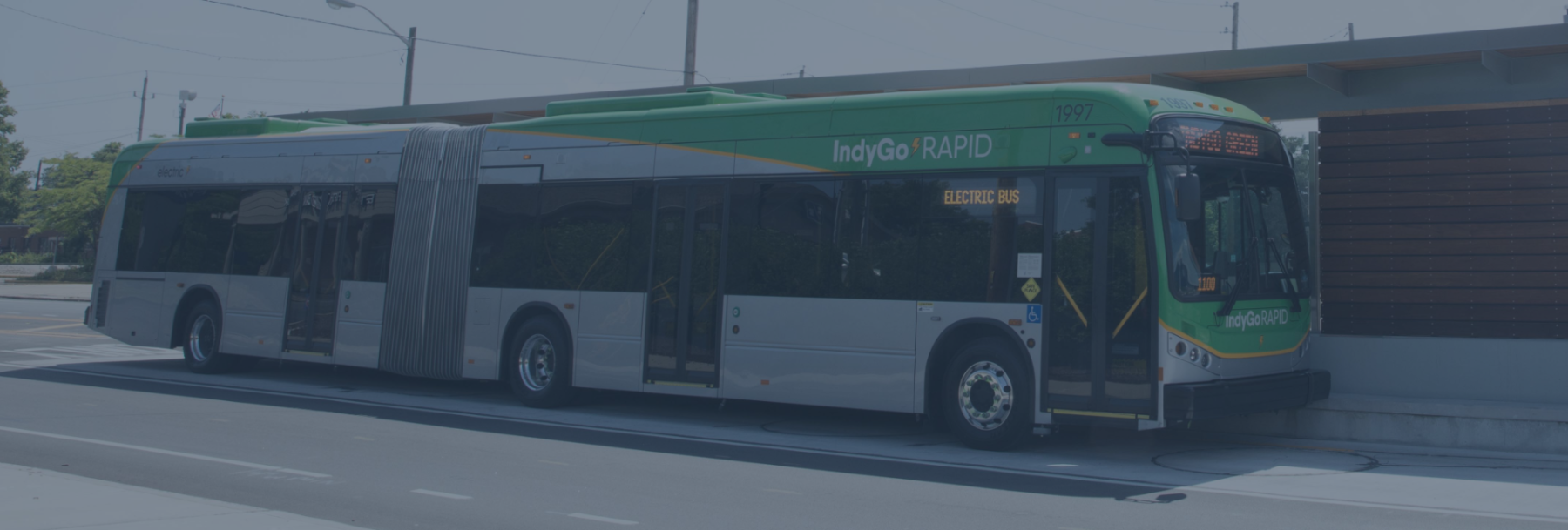 IndyGo bus pulling up to a stop to pick up passengers.