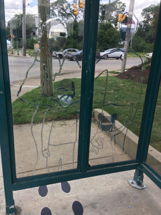 drawing of a family of three at bus stop