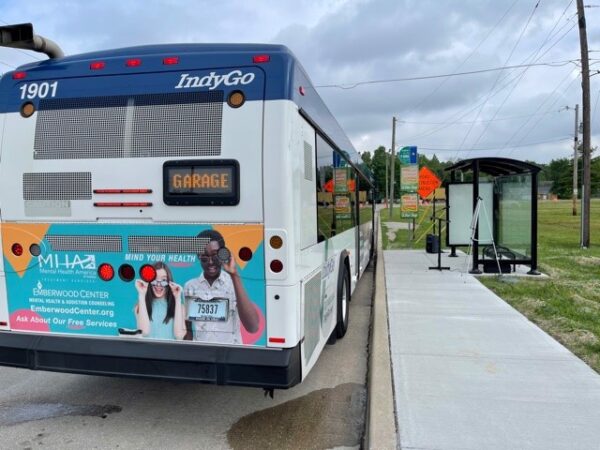 rare of a garage indygo bus at a bus stop