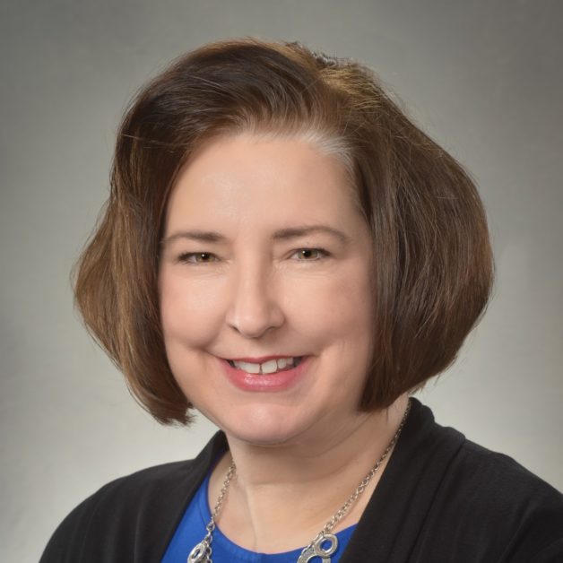 A woman with short hair and a blue shirt.