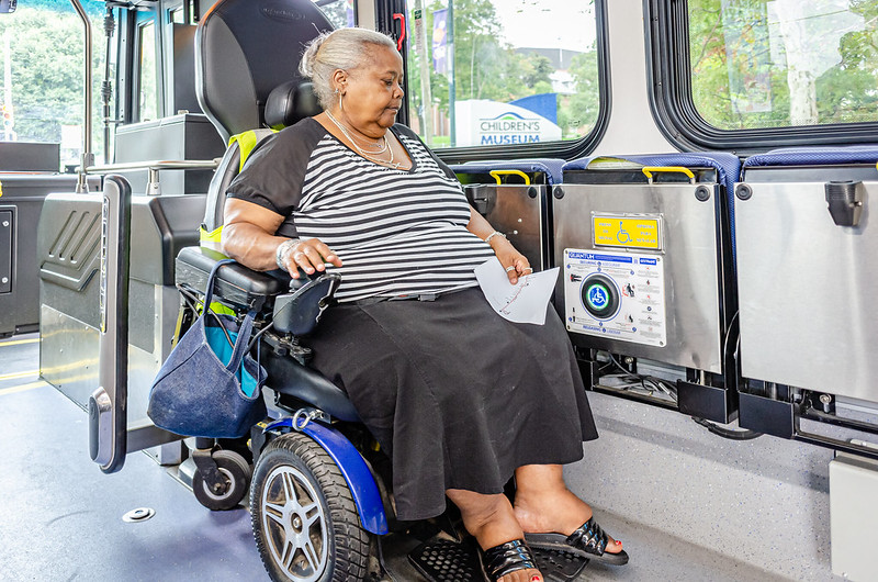 Woman in wheelchair riding bus