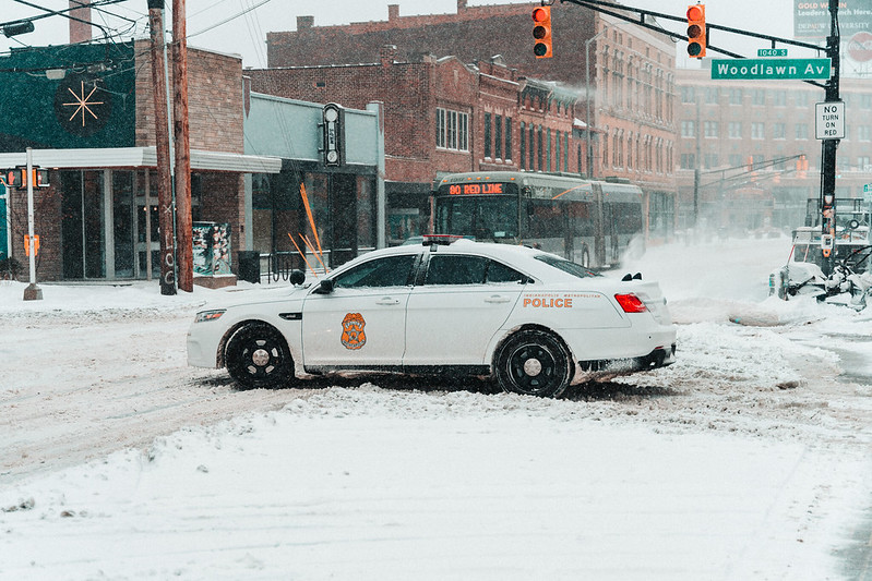 INPD vehicle with bus in background