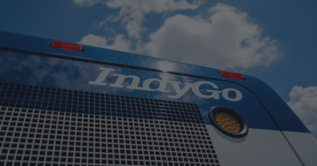 Photo of the IndyGo logo on the back side of an IndyGo bus.