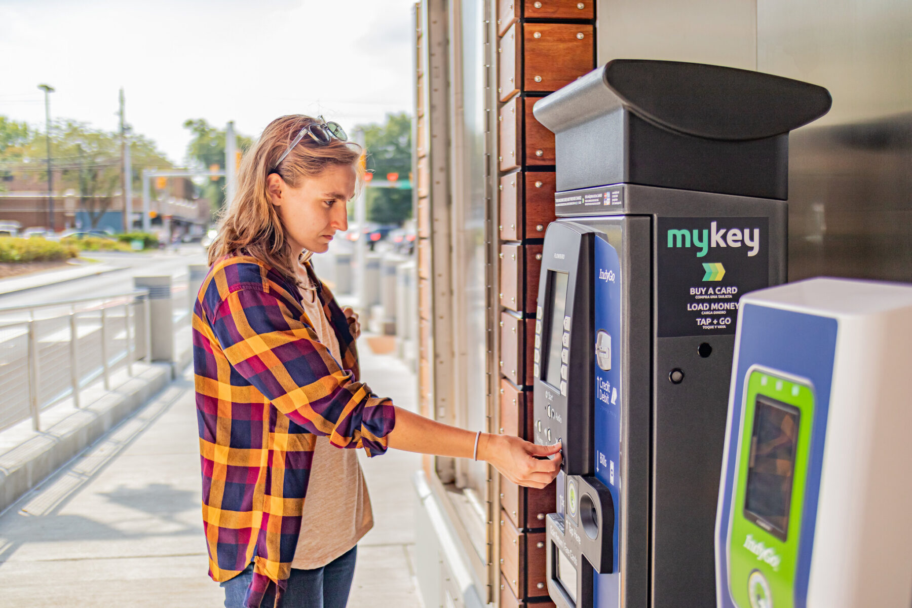 Woman Purchasing Fare at Kiosk