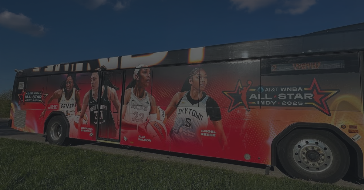 Side shot of an IndyGo bus with a WNBA wrap.
