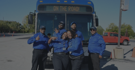Coach operators posing in front of an IndyGo bus on Transit Teammate Appreciation Day.