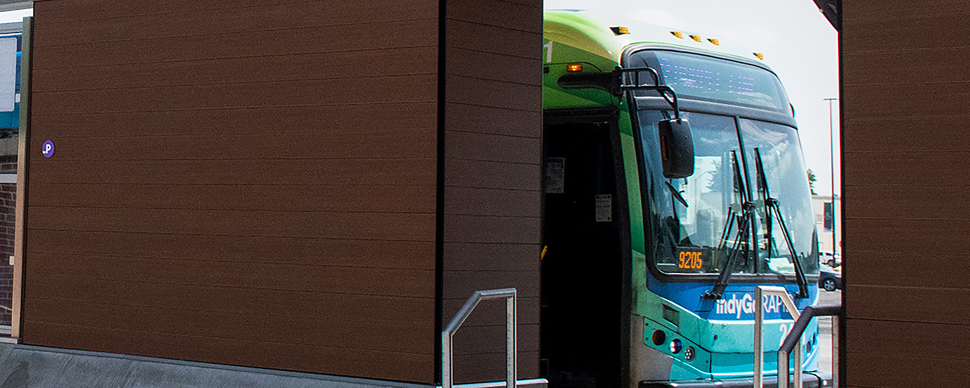 green bus parked at station